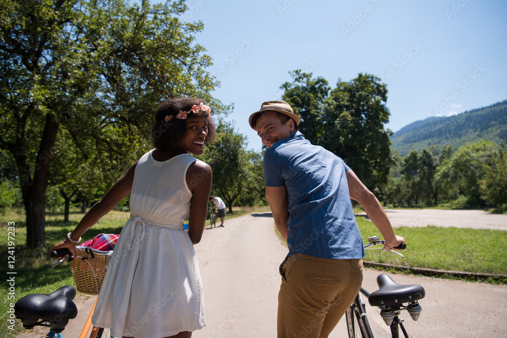 Young multiethnic couple having a bike ride in nature Young multiethnic couple having a bike ride in nature