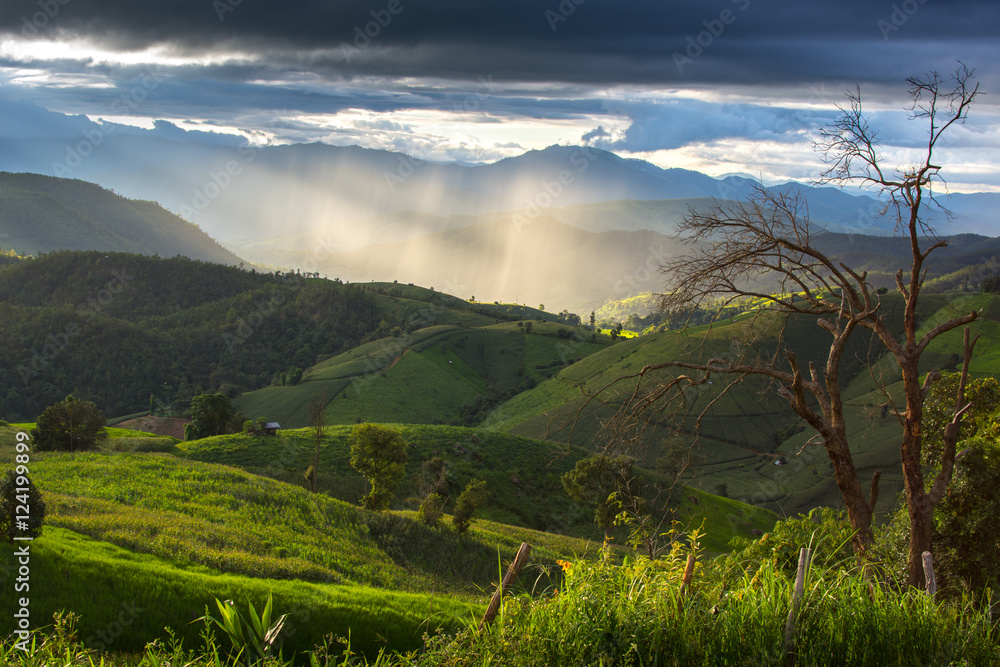 The mountain with background ray lighting in the evening in Mae chaem, Chaing Mai, Thailand The mountain with background ray lighting in the evening in Mae chaem, Chaing Mai, Thailand