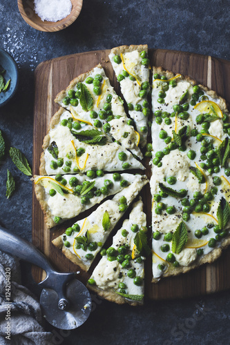 Thin and crisp grilled gluten-free pizza crust (whole grain + gluten-free) and a springy topping of fresh peas, meyer lemon, goat cheese and mint.
