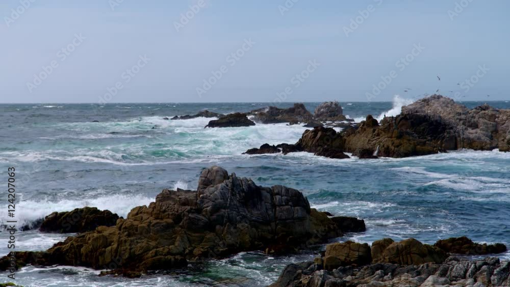 Wide shot of waves crashing on the rocky coast Wide shot of waves crashing on the rocky coast