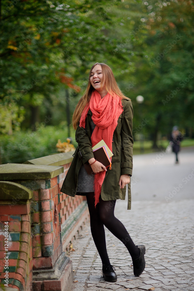 Cute girl walks in the picturesque autumn park.