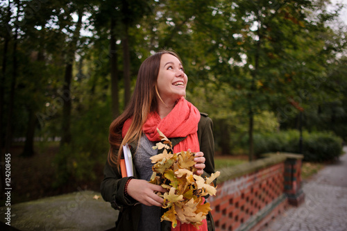 Charming girl walks in the beautiful autumn park.