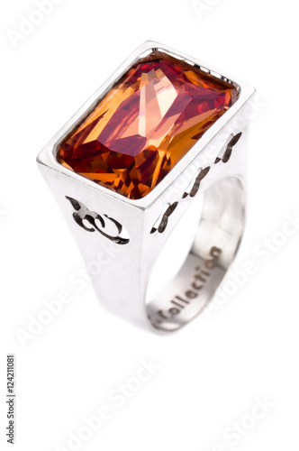 Silver ring with orange gem on an isolated white background