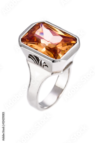 Silver ring with orange gem on an isolated white background