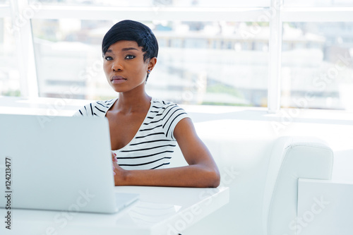 Portrait of a casual young african businesswoman using laptop computer Free Download Portrait of a casual young african businesswoman using laptop computer - GFXLoad