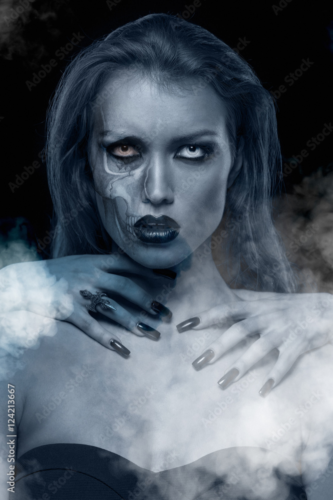 Pretty gothic woman with hands of vampire on her neck