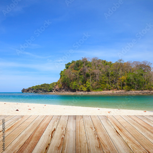 Wood table top on beach background.