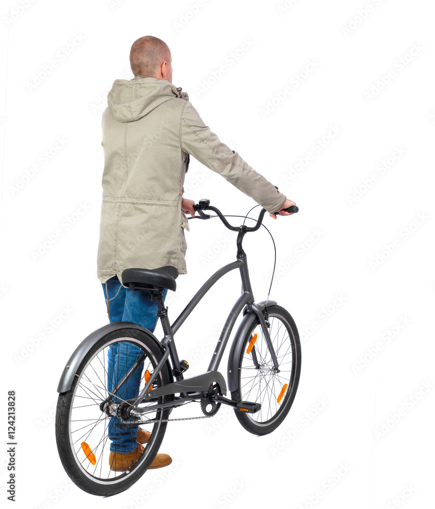 back view of a man with a bicycle. Cyclist in parka jacket keeps the wheel of a bicycle. Rear view people collection. backside view of person. Isolated over white background. back view of a man with a bicycle. Cyclist in parka jacket keeps the wheel of a bicycle. Rear view people collection. backside view of person. Isolated over white background.