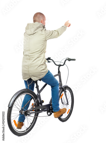 back view of pointing man with a bicycle. cyclist sits on the bike. Rear view people collection. backside view of person. Isolated over white background.