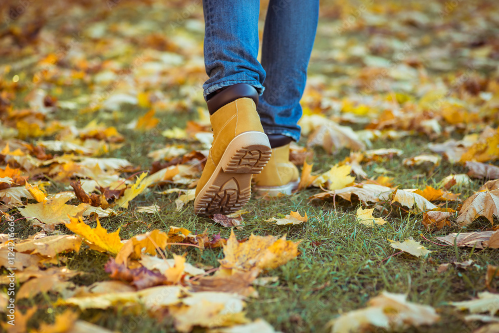 Warm yellow boots. Walking in autumn leaves Warm yellow boots. Walking in autumn leaves