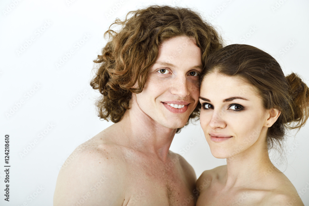 Portrait of young contented couple. Young man and woman embracin Portrait of young contented couple. Young man and woman embracin