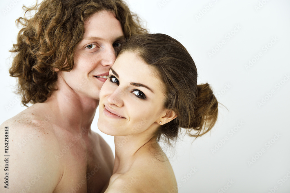 Portrait of young contented couple. Young man and woman embracin Portrait of young contented couple. Young man and woman embracin