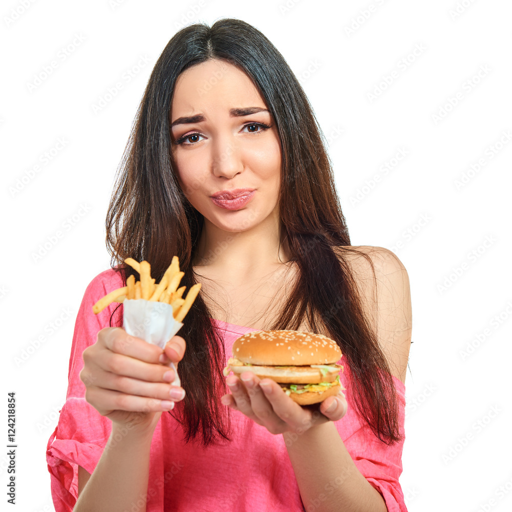 Young woman with fast food. Girl eating hamburger and fries over Young woman with fast food. Girl eating hamburger and fries over