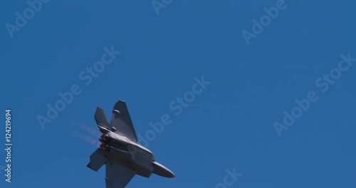Tracking shot of military fighter jet flying in sky