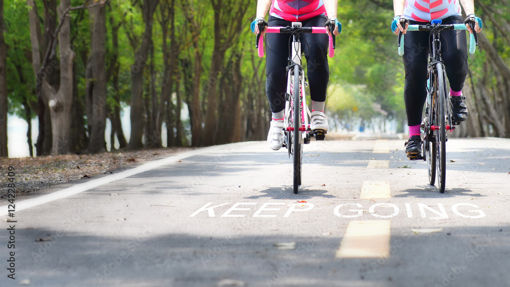 Fototapeta premium Bike lane and words of keep going on road, business concept and success idea