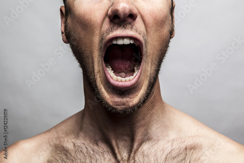 close up portrait of a man shouting, mouth wide open