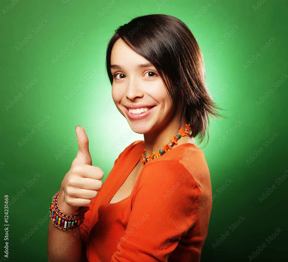 smiling beautiful young woman showing thumbs up gesture smiling beautiful young woman showing thumbs up gesture