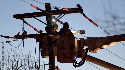 Close up of utility workers working on power line