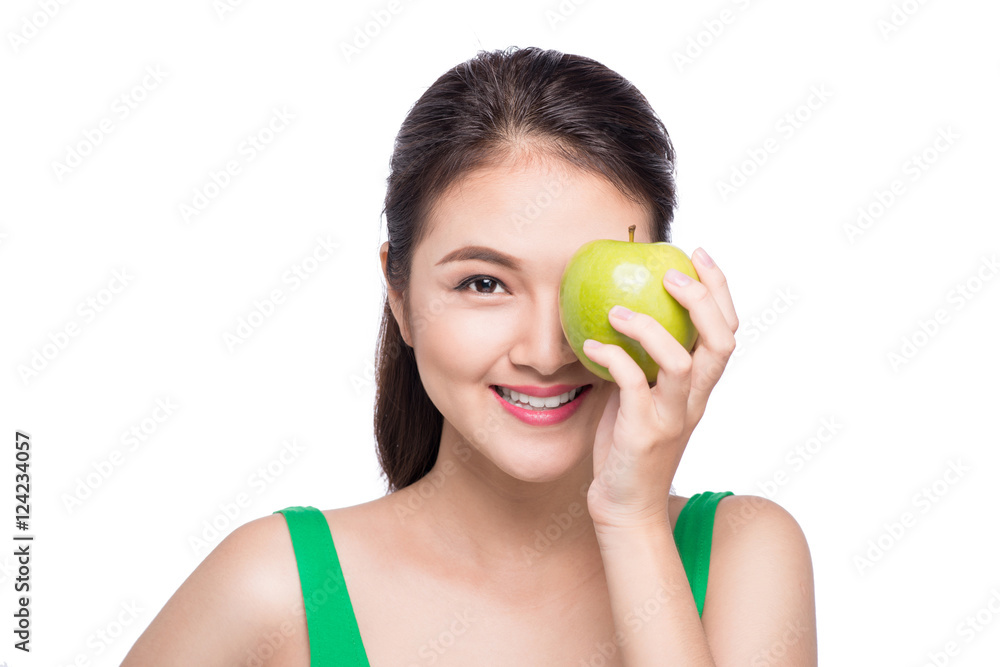 Attractive smiling young asian woman eating green apple isolated Attractive smiling young asian woman eating green apple isolated