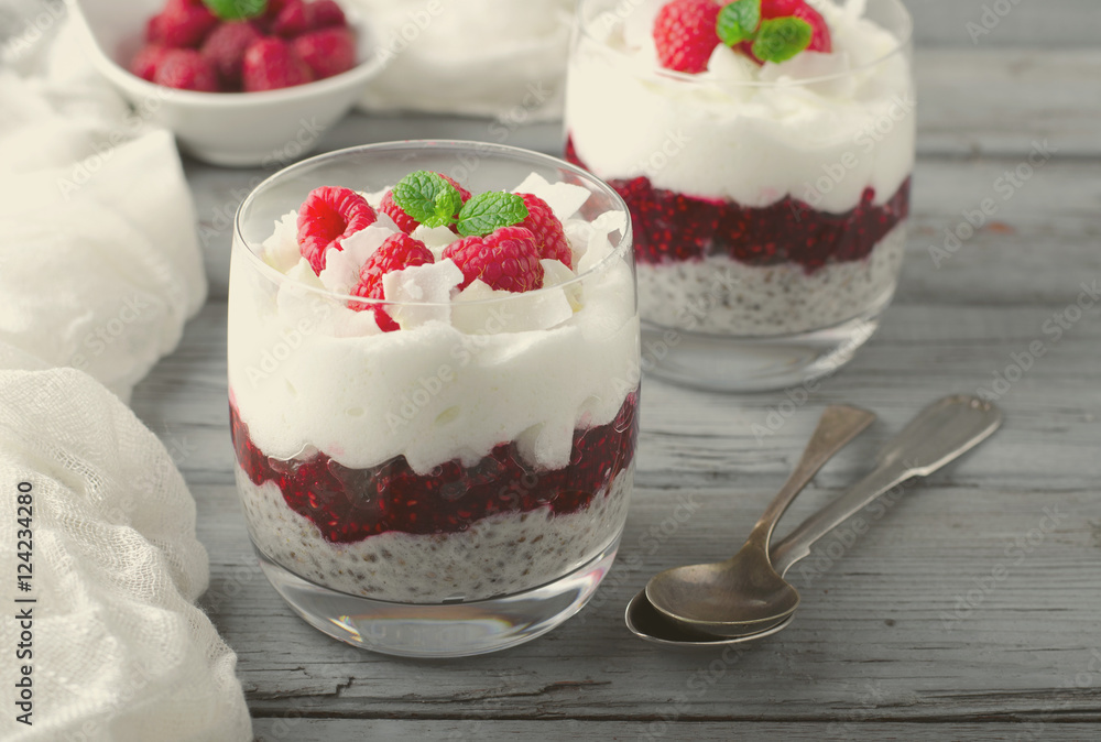 Healthy breakfast, desert, with chia seed pudding, cream, raspberry jam, coconut flakes and fresh berries Healthy breakfast, desert, with chia seed pudding, cream, raspberry jam, coconut flakes and fresh berries