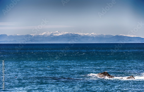 Sea with Mountains/ Ocean/ mountains/ snow/ wintertime/ blue/ white/ cold