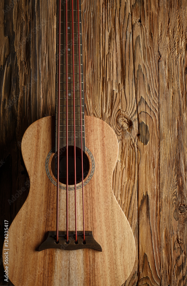 Fototapeta premium ukulele bass on aged wood