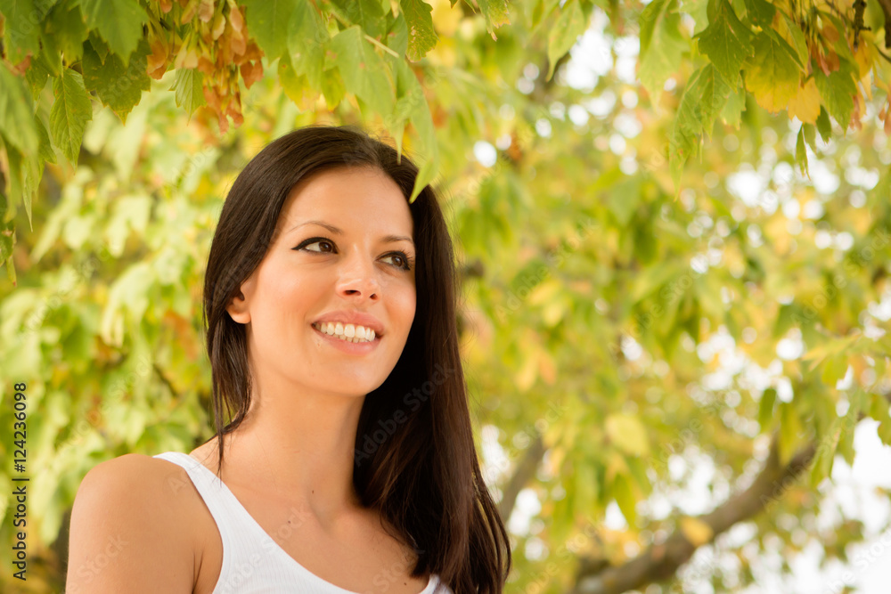 Fototapeta premium Beautiful brunette girl taking a walk in autumn