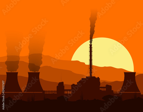 Silhouette of a nuclear power plant at sunset. 
