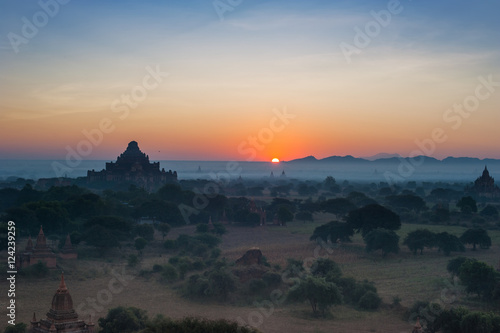Amazing misty sunrise colors and silhouette of ancient Dhammayan Gyi Pagoda. Architecture of old Buddhist Temples at Bagan Kingdom  Myanmar  Burma . Travel landscapes and destinations