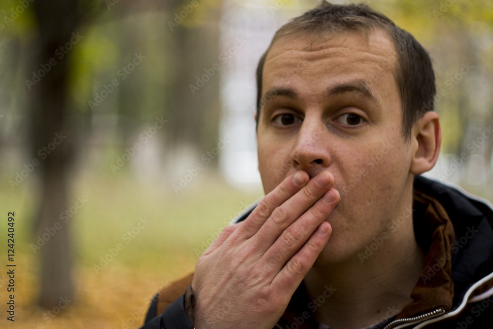 the young man is surprised at the nature and background of yellow leaves the young man is surprised at the nature and background of yellow leaves