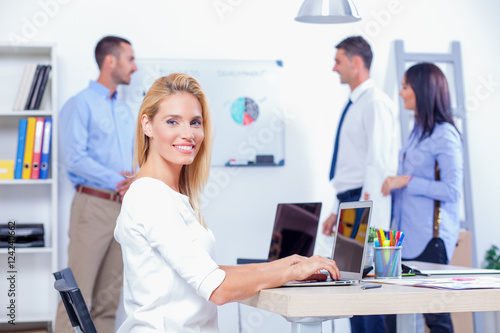 Group Of Business People Having Meeting In Office. Business partners discussing documents and ideas at meeting