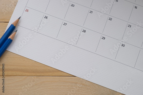 close up calender date and pencil on wooden background