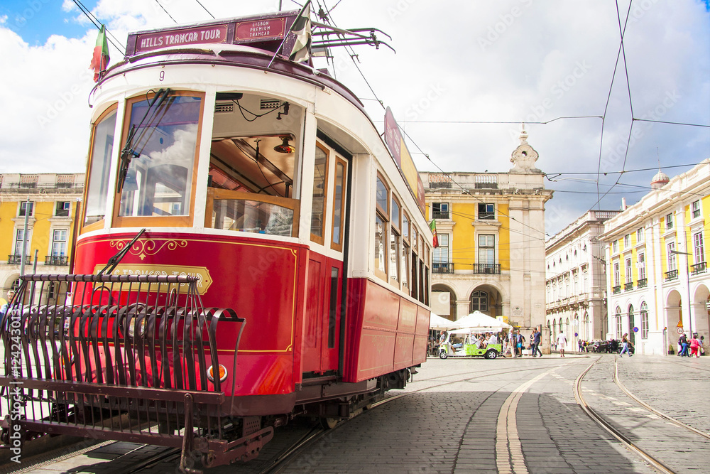 Famous old red tram on street of Lisbon/Lisboa.Plaza de comercio