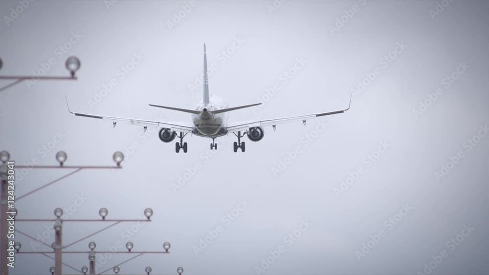 Slow motion of commercial airplane flying over runway Slow motion of commercial airplane flying over runway