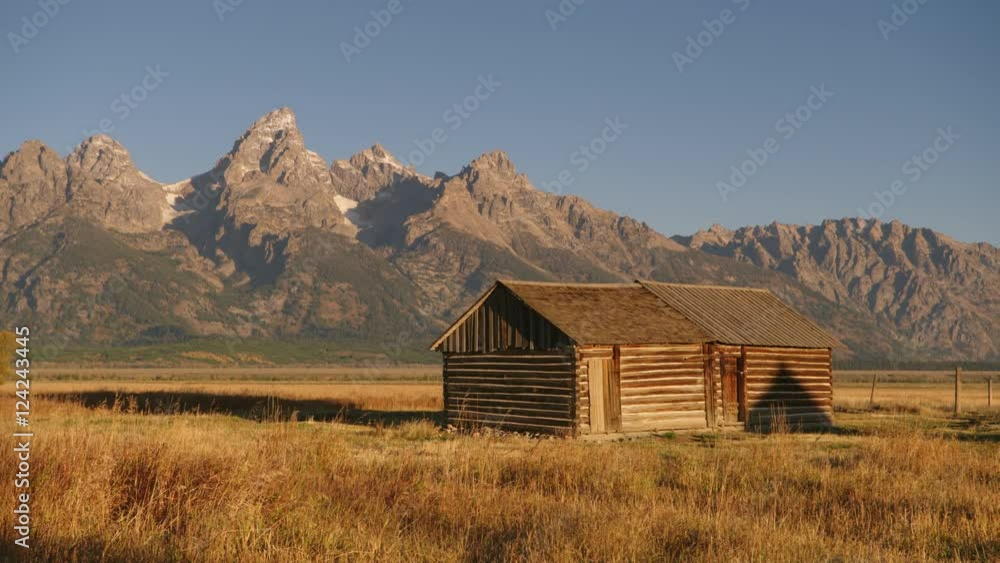 Wide shot of barn against Rocky Mountains at Grand Teton National Park Wide shot of barn against Rocky Mountains at Grand Teton National Park