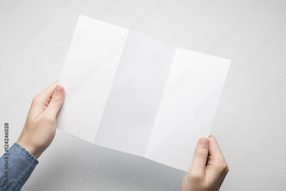 Obraz premium Hands are holding a Dl Z-Fold white paper poster