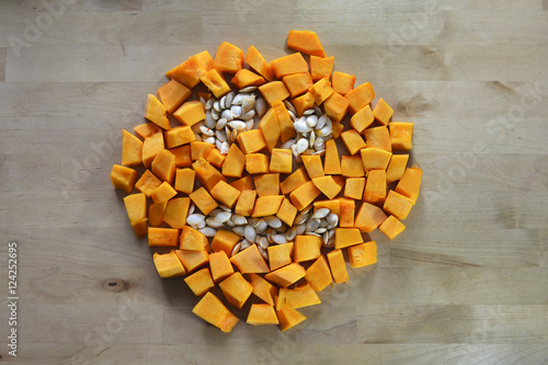 Halloween pumpkin sliced with seeds on a wooden table