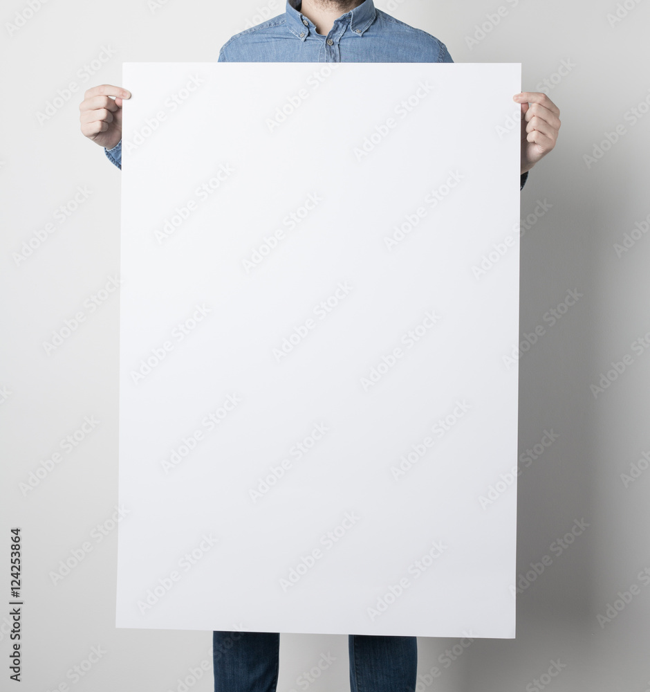 Fototapeta premium Man holding a white poster