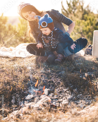 Young mom with kid on the mountains