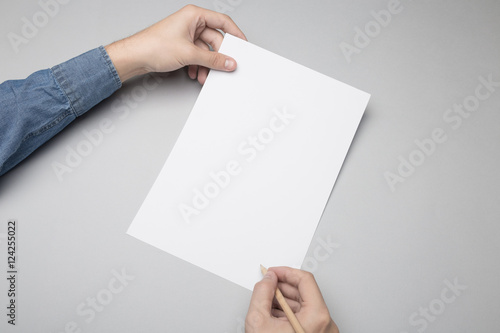 Hand is writing on A4 paper