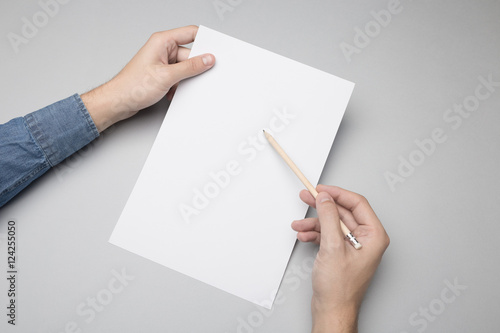 Hand is writing on A4 paper