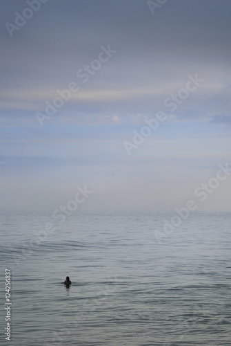 Girl taking an early morning swim in the sea