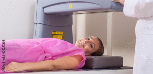 Konstfotografi Woman in 40s undergoing open mri with doctor supervising