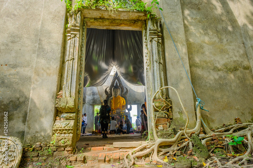 A public ancient Thai Buddha statue left in the forest for hundred years in Wat Somdej temple ,Sangkhaburi,Kanchaburi,Thailand. .Photo taken on: October 14, 2016 photo