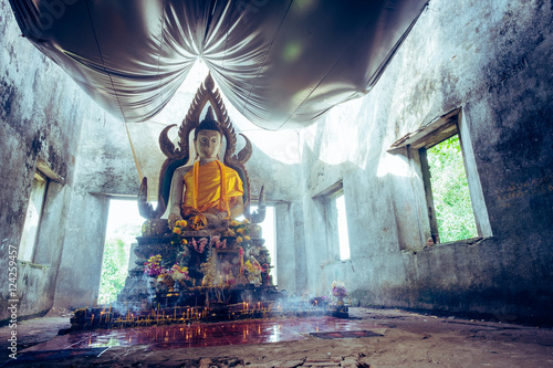 Vintage style photo, A public ancient Thai Buddha statue left in the forest for hundred years in Wat Somdej temple ,Sangkhaburi,Kanchaburi,Thailand. .Photo taken on: October 14, 2016