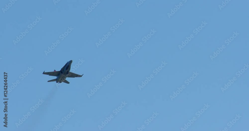 Tracking shot of military jet airplane flying in blue sky Tracking shot of military jet airplane flying in blue sky
