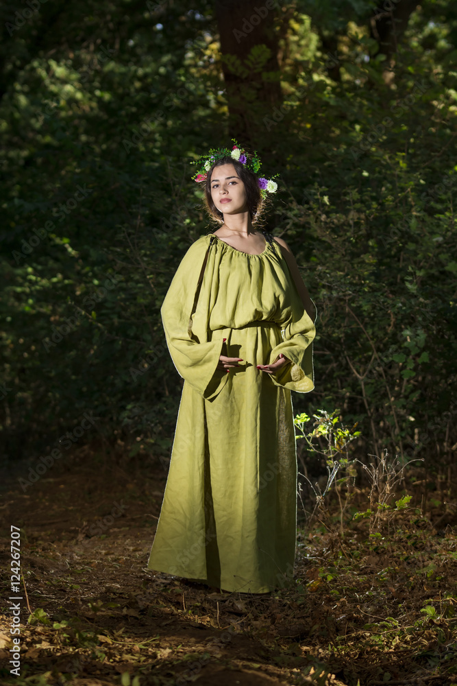 Naklejka premium Fantasy Fairy Tale Forest , young woman posing as nymph