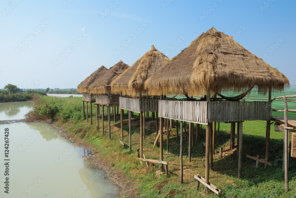 The thatched gazebo on stilts under the scorching sun