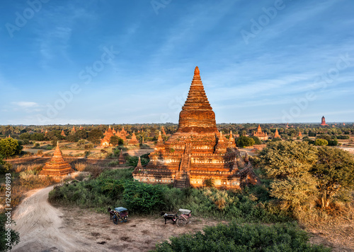 Travel landscapes and destinations. Tourists horse carriage in front of ancient Mahazedi Pagoda. Amazing architecture of old Buddhist Temples at Bagan Kingdom  Myanmar  Burma 