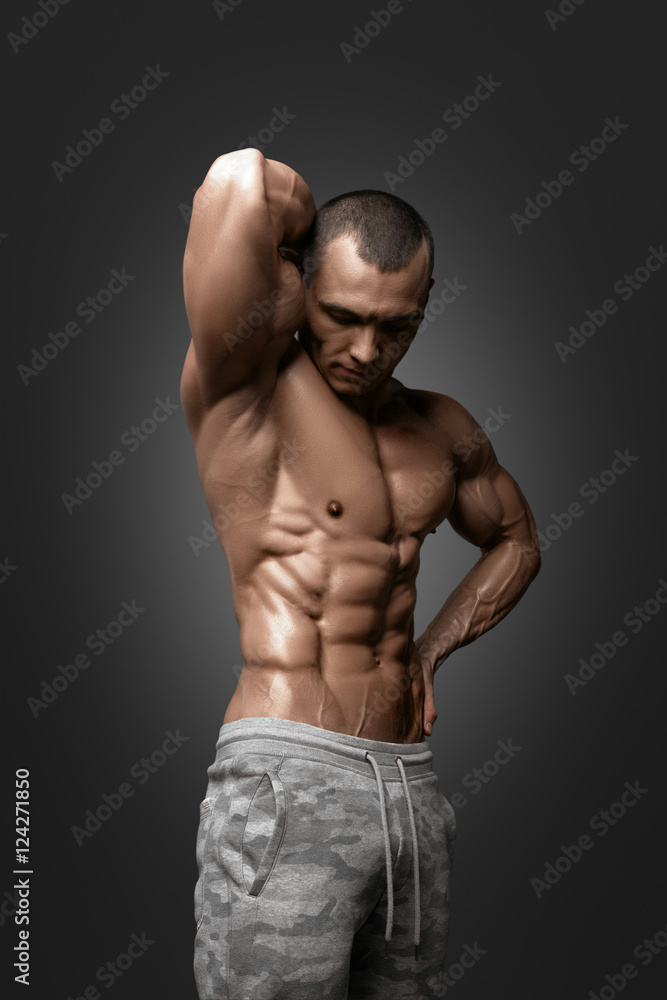 Fototapeta premium Strong Athletic Man Fitness Model Torso showing six pack abs.